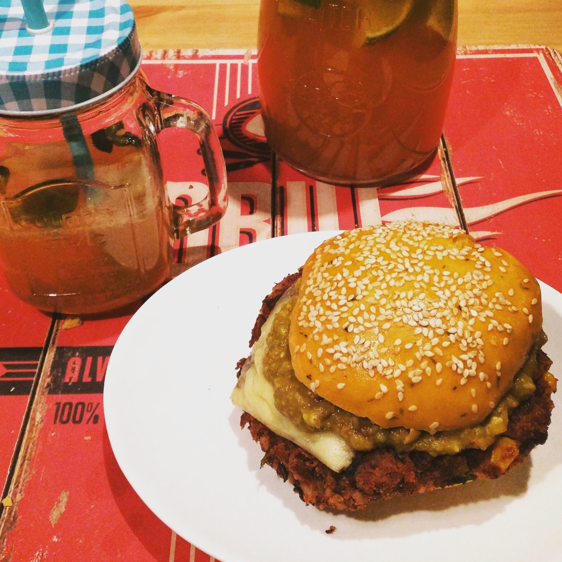 Kidneybohnen Cheese-Burger mit Koriander-Salsa und Guacamole auf einem Salsa-Brioche Bun